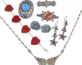 (9pc) STERLING JEWELRY | Sterling silver jewelry, including: a pair of art nouveau earrings with blue enamel, an English bar pin with copper decoration and London hallmarks with makers mark "F. V.", a triangular green stone pendant necklace with marcasite [chain separated from one side of pendant], a bracelet with red hearts, a blue wreath pin with bow, a pin with striated red stone, and a pair of purple stone earrings; all together 3.28 ozt.
