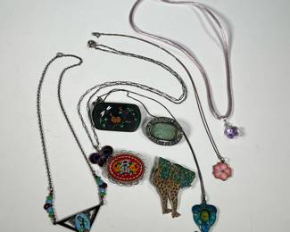 ENAMELED STERLING JEWELRY | Including a sterling and ancient Roman glass pin and a micromosaic pin; plus enameled silver jewelry, including a closoinne and vermeil pin, a flower pendant necklace, a butterfly necklace, a giraffe pin, a triangular pendant necklace, and a blue-green pendant necklace (each with sterling chains); gross weight 2.43 ozt; plus a a purple crystal necklace with sterling clasp
