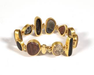 SHAW JEWELRY 22K GOLD SPECIMEN BRACELET | Shaw Jewelry, Northeast Harbor, Maine; having figural natural stone links set in 22k yellow gold with 14k yellow gold hardware, with a locking magnetic clasp
7 x 0.75 in., 49.8g
