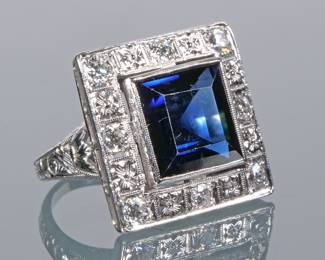 ANTIQUE SAPPHIRE & DIAMOND RING | Designed as a synthetic blue sapphire bezel mounted in a border of colorless melee diamonds in an engraved platinum ring. 9.7g
