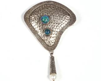 RHONDA SHIKANAI STERLING PIN | Two lapis cabochons set in a hand-wrought sterling silver brooch with a drop pendant suspending a natural pearl, signed on verso. 0.51 ozt, h. 3.25 in.
