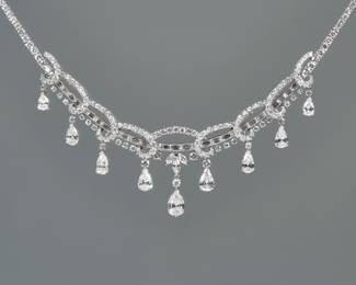 ANTIQUE DIAMOND FESTOON NECKLACE | Designed as a continuous line of baguette channel-set baguette diamonds and prong-set full-cut diamonds suspending nine graduated pear brilliant cut diamonds interspersed with a line of prong-set graduated full-cut diamonds and decorated with scrollwork mounting prong-set full cut diamonds. 15 in., 59.6g, 21.17 cttw. 
