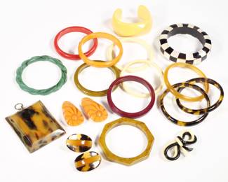 BAKELITE COLLECTION | Bakelite and other jewelry, including 13 bracelets, a pair of orange clips, a double bow pin, a pair of earrings, and a small picture frame (3-1/28 x 2-1/2 in.)
