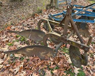 Vintage farm tractor implements/plows.
