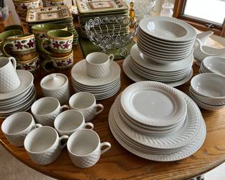 Two sets/partial sets of white dinnerware.
