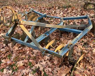 Vintage farm tractor implements/plows.