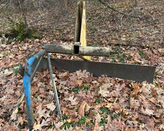 Vintage farm tractor implements/plows.