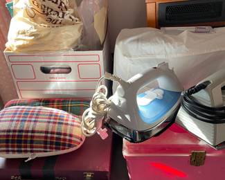 Singer sewing machine (see next photo for a close-up w/no cover); irons; EdenPURE GEN30 Classic infrared heater (see close-up in photo to follow).