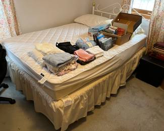 Queen-size bed with metal headboard (includes mattress and box spring).