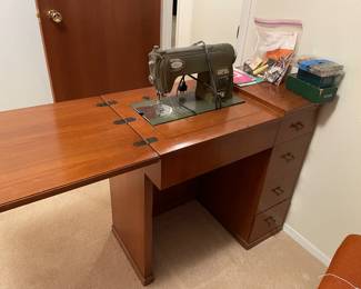 White vintage sewing machine with cabinet