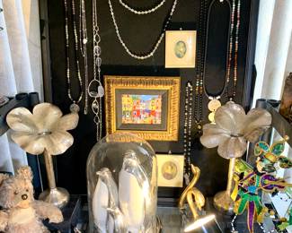 Well loved vintage Zotty Steiff bear. 18" dome with 3 large silver coated Penguins from Z Gallery. Vintage gold coated and glass swans. Silver plated flower candle sticks fashioned after Italian Designer. Oil painted Michael Wood small framed pictures and natural stone necklaces.