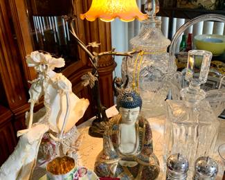 M.Moreau Bronze Art Nouveau swinging girl lamp-reproduction. Signed paper cache' sitting girl. Buddha sitting enameled. Crystal and glass decanters and large candy jar. Vintage demitasse cup and saucer.