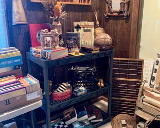 Antique saddle frame, 2 printers drawers, Antique wood bucket and wood hand wringer, decor bells, Underwood #5 Typewriter and picture frames. Not showing: Primitive Wood Stool, DeJur 750 #5 Projector,Ore Cart decor