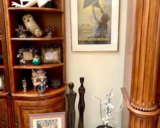 2 of the 3 pieces to the wall unit. Vintage framed posters.Cast Iron art work decor pieces. Artwork decor