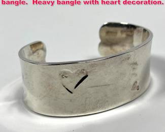 Lot 1775 Tiffany and company sterling silver bangle. Heavy bangle with heart decoration.