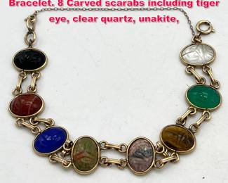 Lot 1870 10K Gold Natural Stone Scarab Bracelet. 8 Carved scarabs including tiger eye, clear quartz, unakite,