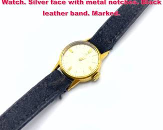 Lot 1829 Gold Vintage MOVADO Ladies Wrist Watch. Silver face with metal notches. Black leather band. Marked. 