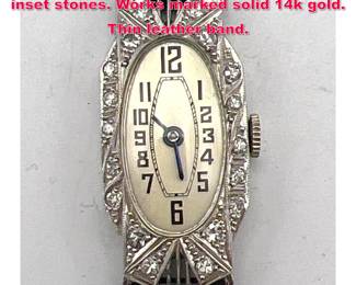 Lot 1825 Filigree Platinum ladies watch with inset stones. Works marked solid 14k gold. Thin leather band. 