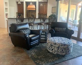 Two lazy boy club chairs
La-Z-Boy ottoman with place for blankets and beautiful rug

