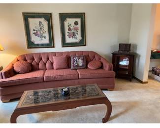One of several couches, this one is  three cushion vintage mauve upholstery in excellent condition.  Notice the coffee table, next photo will show a close up of the carved wood on this beautiful table