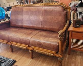 Mid Modern 1950's faux alligator skin couch with carved carved lions on the Arms