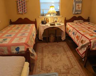 PAIR OF VINTAGE TWIN BEDS PAINTED BURNT RED WITH BONNET GIRL QUILTS