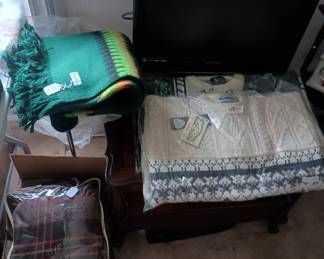 Wool items
Irish sweaters,   travel blanket in  package, and
