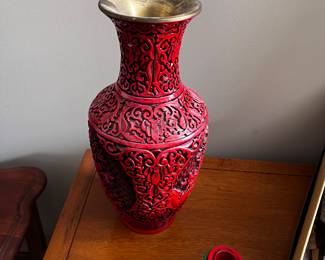 red vase and candleholders