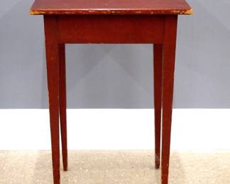 A 19th century American painted lamp table.  Pine construction with a beaded apron and tall tapered legs.  Original Red painted finish.  Some wear, lacks one glue block at underside.  17 x 18 1/2 x29" high overall.