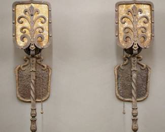 A pair of early 20th century Gothic Revival Period sconces.  Cast Brass bodies with single lights and Shield design with foliate details, patinated finish and Mica liners.  Some wear to finish and pitting.  Each 16" high.