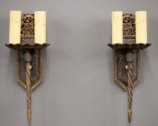 A pair of early 20th century Gothic Revival Period sconces.  Cast Iron bodies with British Coat of Arms design, two lights and patinated finish.  Minor wear to finish.  Each 14" high.