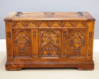 A turn of the century Gothic Revival Period carved Oak blanket box.  Paneled lift top with Iron hinges over a three panel facade with carved tracery on a molded bracket base.  Old finish with some wear and fading, particularly to top.  40 x 18 1/2 x 24 1/2" high overall.