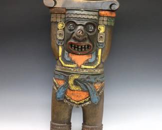 An early 20th century Heywood Wakefield Cast Iron seat end from the Fisher Theater in Detroit, MI.  Cast Iron body in the form of a Mayan Warrior holding a shaped wooden armrest with inset glass eyes, nose and polychrome finish.  Wear to finish and wood, lacks internal wiring.  24" high.