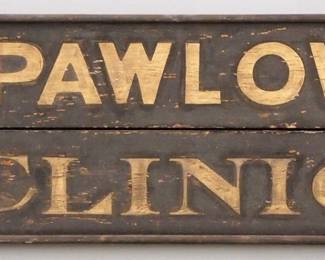 A turn of the century wooden Trade Sign advertising "Dr. J. Pawlowski, Clinic".  Single sided painted wooden sign with Gold lettering on a Black schmaltz background.  Some surface wear, some paint loss.    61 1/2" long x 14 1/2" high overall.