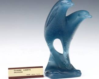 A late 20th century Daum Pate de Verre sculpture designed by Claude Lhoste, titled "Dauphins".  Depicts a pair of dolphins leaping from stylized waves in tones of Blue.  Cast "Lhoste" and "Daum France" at base, numbered "29/300" at underside.  Minor wear.  8 1/2" high.