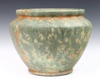 An early 20th century Burley Winters Art Pottery jardiniere, c. 1930.  Bulbous form with releif geometric decoration and mottled Orange/Green glaze.  Impressed "Burley Winter / Cooksville, OH" at underside.  Minor surface wear.  13" diameter x 10" high overall.