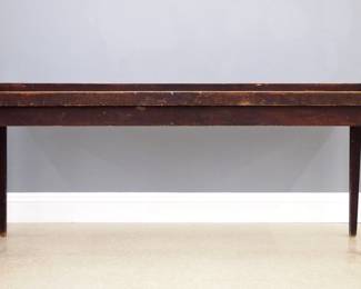 A turn of the century American painted sorting table.  Mixed wood construction with an applied tray top and simple tapered legs.  Original Reddish Black painted finish.  Overall wear, top re-attached, legs loose with added screws.  20 1/2 x 85 x 34" high overall.