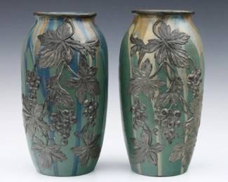 A pair of early 20th century French Art Pottery vases by Jean and Leon Pointu.  Baluster forms with applied metal Grape Vine decoration and multi-color drip glaze.  Both with incised "Pointu Fils" signatures at underside.  Minor wear.  Each 10 1/4" high.