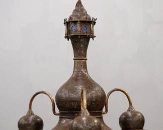 An early 20th century Moroccan style chandelier.  Four light design with pierced Brass construction, inset Cobalt glass liners and three downturned arms with silk fringe accents.  Some welded repairs and wear to patina, replaced silk fringe.  Approx. 36" diameter x 40" high overall.