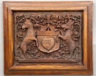 An early 20th century Gothic Revival Period Heraldic carved Oak panel.  Carved Coat of Arms with two unicorns flanking an arrow pierced shield with heart surrounded by scrolling florals.  Original dark finish minor wear.  Panel 19 x 15" high, in a molded Oak frame, 24 1/2 x 20 1/2" high overall.