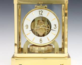 A late 20th century Le Coultre Atmos clock.  15 jewel caliber 528 perpetual movement with White enameled dial and Arabic numerals.  Brass case with glass inserts.  Minor wear, running when cataloged.  9 1/4" high.