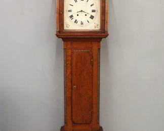 A turn of the century French Gothic Revival tall clock retailed by Dupin & Strembel, Paris.  Junghans 8-day, spring driven time and strike movement with quarter hour strike, Silvered dial and Arabic numerals.  Carved Gothic Revival case with central spire flanked by smaller spires, single door with carved tracery and arched dial glass, central waist door with one arched panel over linen fold panel with arched quarter columns on a stepped base with carved linen fold design and heavy molded foot.  Old finish with very minor wear, running when cataloged, strike needs adjustment.  21 1/2 x 11 1/2 x 102" high overall.