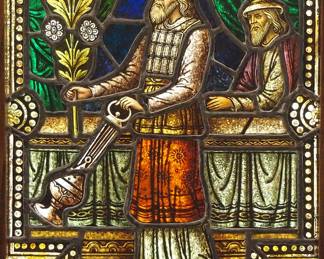A Gothic Revival stained glass window of the Prophet Aaron.  Multi-color stained and leaded glass panels with reverse painted detail depicting the Prophet and High Preist Aaron, brother of Moses, holding a censer and palm frond within geometric and foliate borders.  Panels intact, some wear to paint.  In a later Oak frame, 19 1/8 x 28 1/4" high overall.