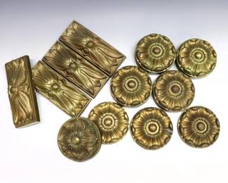 Twelve early 20th century Brass architectural elements from the The Michigan Central Railroad Depot in Detroit, MI.  Includes four rectangular and eight circular floral embellishments from a MCRR chandelier.  Labeled and dated "1912" by hand at backs.  Some wear to patinated finish.  6 1/4" long and 3 3/4" diameter.