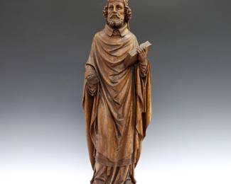 A 19th century carved hardwood figure of Saint Patrick.  Older finish with slight wear, repaired hand lacking fingers.  22 1/4" high.