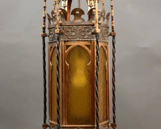 A turn of the century Gothic Revival Period pendant light.  One light design with hexagonal Copper body, domed crown, cast quatrefoil design and twisted spires with textured Amber glass inserts.  Some wear to patina.  12 1/2 diameter x 34" high overall.