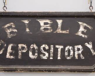A turn of the century wooden Trade Sign advertising "Bible Depository".  Double sided painted wooden sign with White lettering on a Black background.  Some surface wear, edge damage.  39 1/2" long x 17 1/2" high overall.