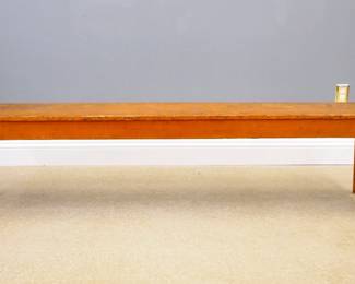 A 19th century painted bench.  Pine construction with single board top, tapered legs with pegged, mortise and tenon joinery.  Original Yellow/Brown grain painted finish.  Some wear, small repair to one corner.  13 x 98 1/2 x 21" high overall.