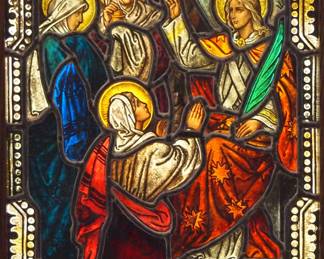 A Gothic Revival stained glass window of the Three Marys.  Multi-color stained and leaded glass panels with reverse painted detail depicting the Three Marys before the Angel guarding Christ's tomb within geometric and foliate borders.  Panels intact, some wear to paint.  In a later Oak frame, 20 1/4 x 29 3/4" high overall.