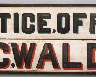 A turn of the century wooden Trade Sign advertising "Justice Office, C. C. Waldo".  Single sided painted wooden sign with Black lettering highlighted in Red or Green on a White background.  Some surface wear.  72 3/4" long x 25 1/2" high overall